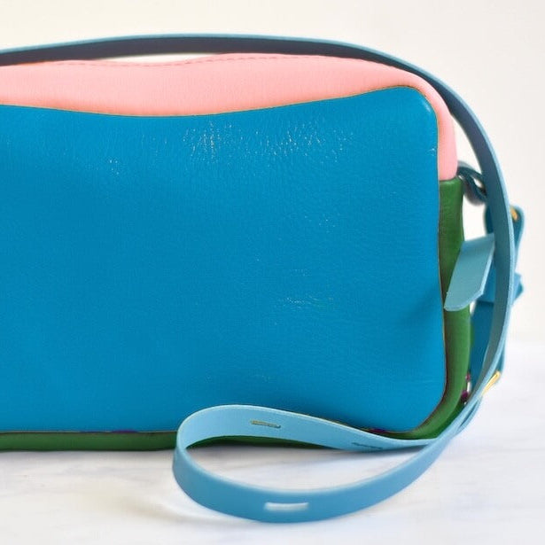 Multicolored handbag with a strap on a white background