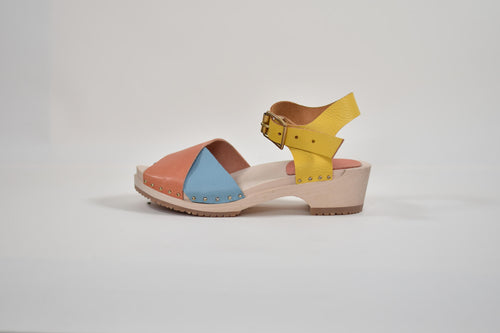 Colorful sandal with a yellow strap on a light gray background