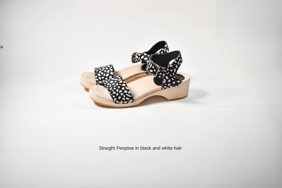 animal print clog sandal in black and white hair leather on white background