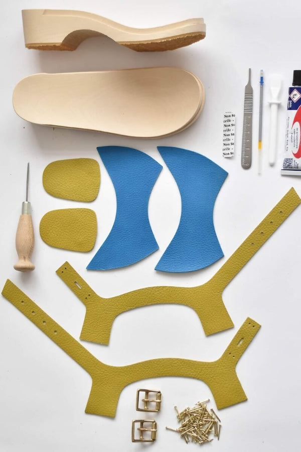 contents of DIY Clog Making Kit with leather uppers tools and wooden clog bases