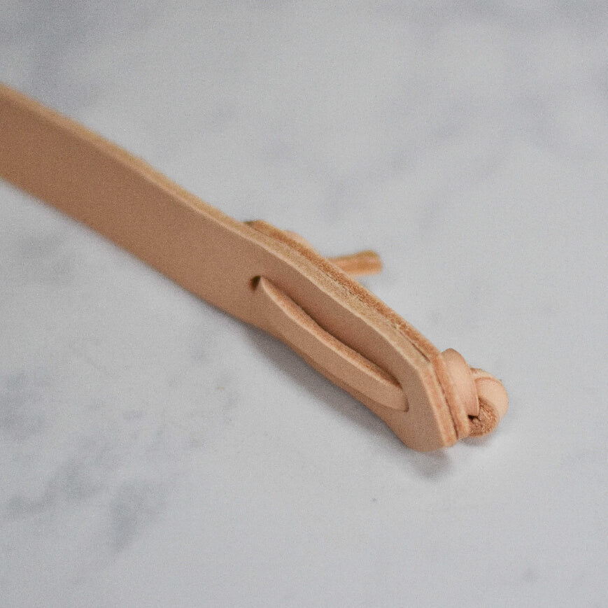 close up of leather thonging bag handle 