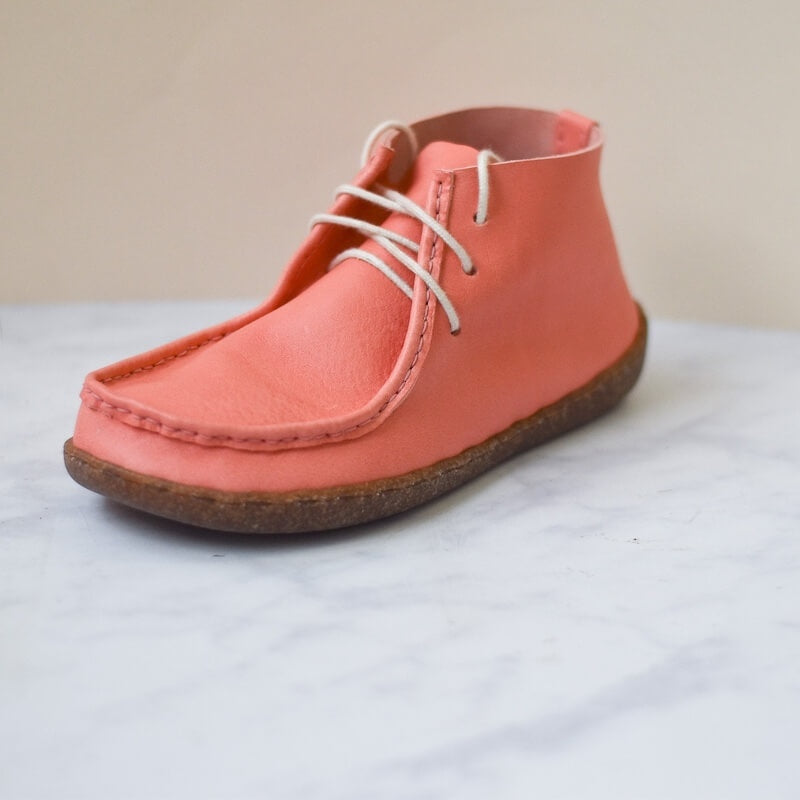 pink leather boot with white laces on white background
