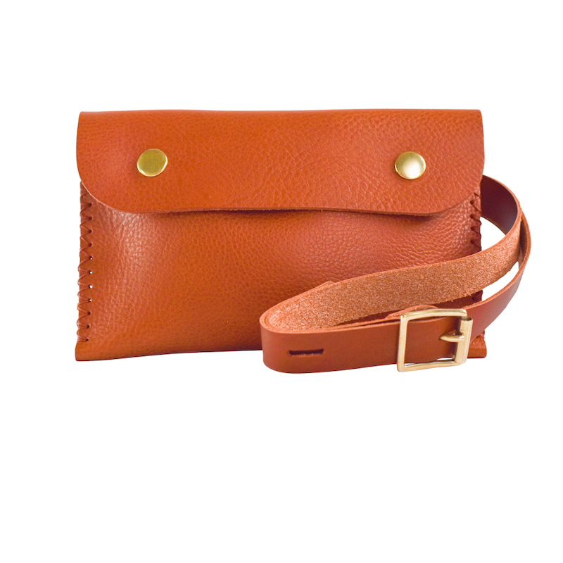 tan leather shoulder bag with brass poppers