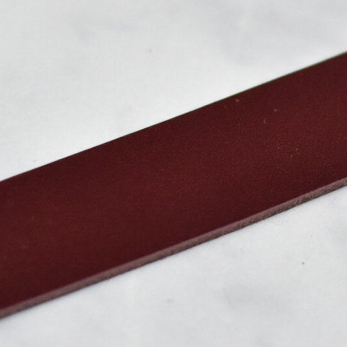 close up of burgandy veg tan leather strap